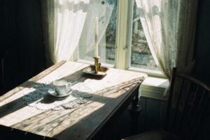 A photo of a table near a window.