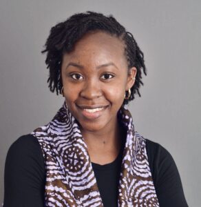 Photo of Charmaine in a black shirt with a scarf over top